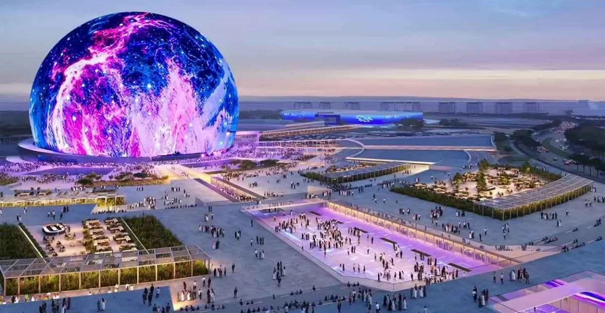 Concept render of the Sphere Abu Dhabi entertainment venue with its illuminated globe and public plaza at dusk