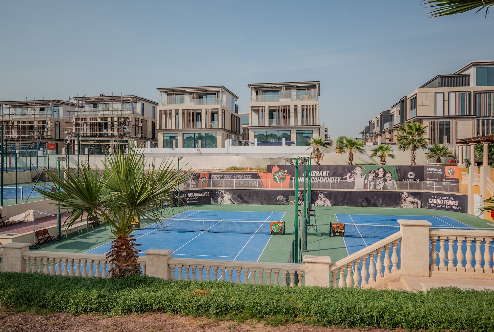 The Jasmine and neighbouring Signature Mansions overlooking the Jumeirah Golf Estates tennis courts